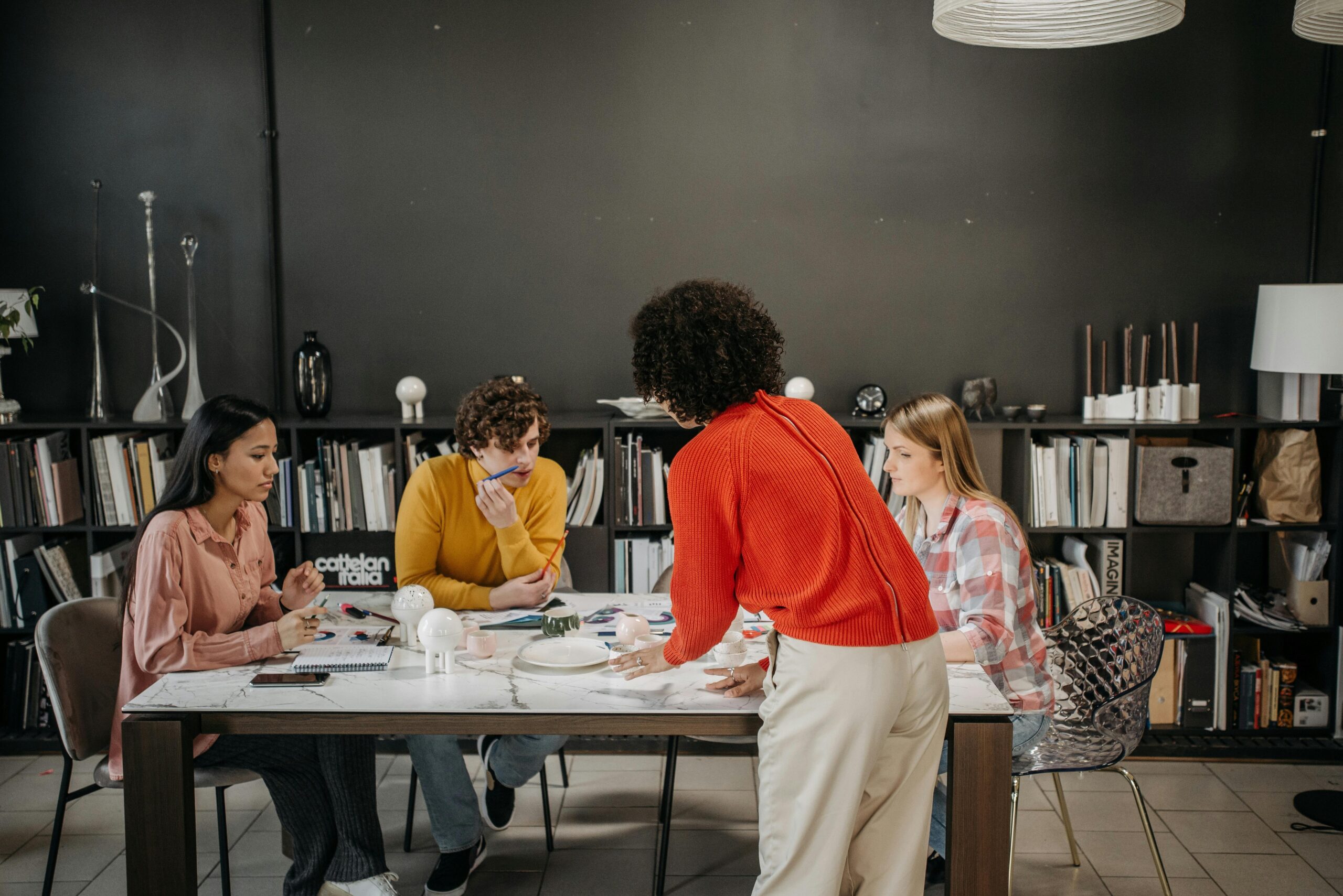 People discussing cybersecurity scan reports around a table
